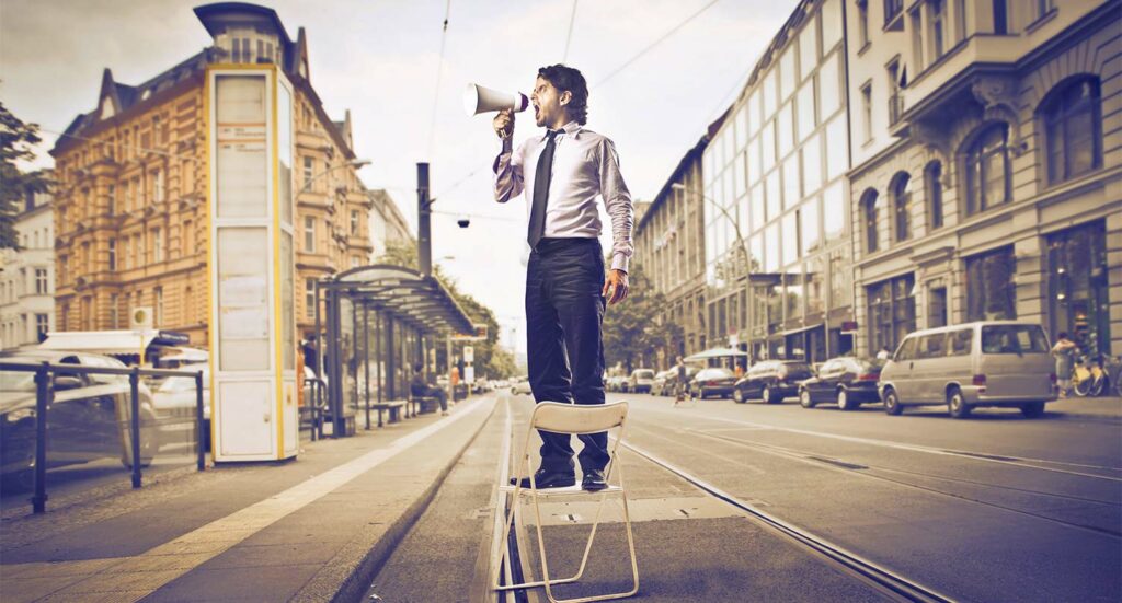 Salesman with Bullhorn in road - Marketing Medicare supplement insurance