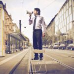 Salesman with Bullhorn in road - Marketing Medicare supplement insurance