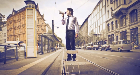 Salesman with Bullhorn in road - Marketing Medicare supplement insurance