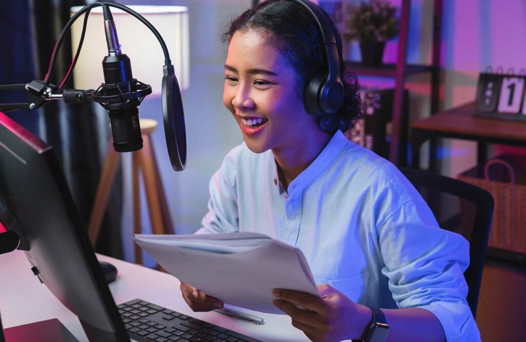 Woman recording a podcast at her computer