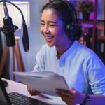 Woman recording a podcast at her computer